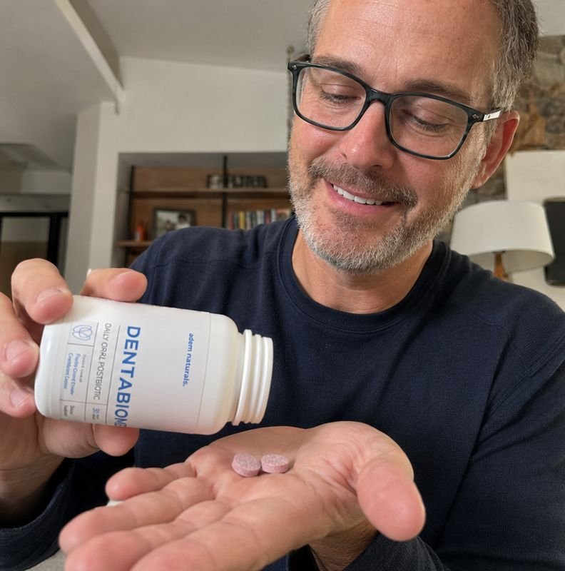 Pouring a DentaBiome chewable tablet into hand